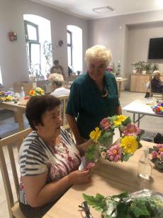Powiększ zdjęcie: Seniorki z Dziennego Domu Senior Plus podczas zajęć manualnych z bukieciarstwa wykonują wianki
